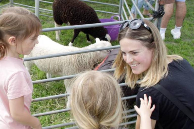 A family at one of Ipswich Borough Council's Family Fun Days in 2023 with some farm animals