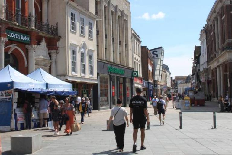 People walking through Ipswich Town Centre on a summmer's day