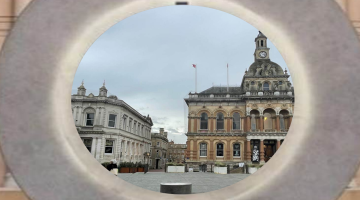 A circular stone sculpture showing a view of a town square