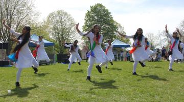A group of people performing traditional Indian dance in a park